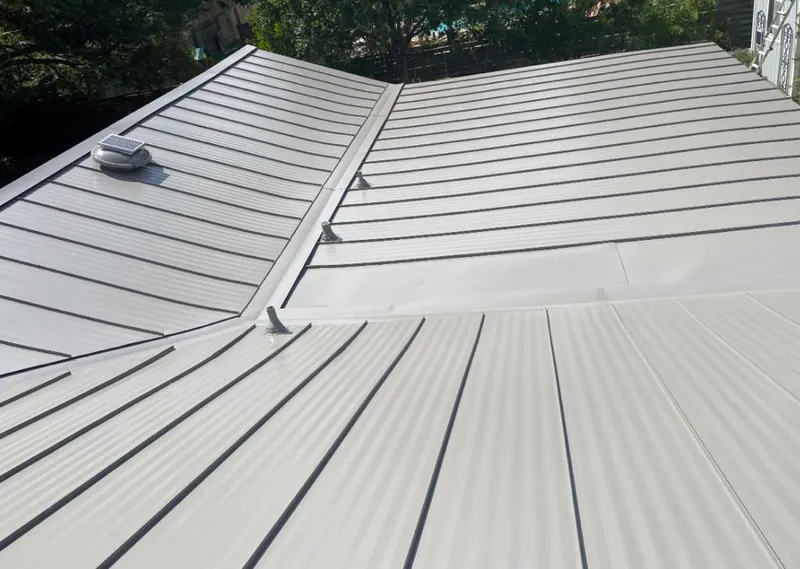 Solar attic fan installed on a metal roof for Roof Ventilation in Zebulon